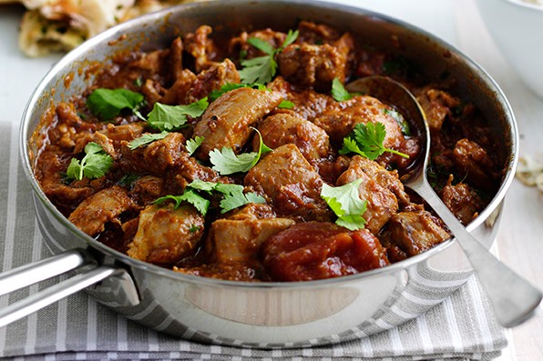 Pan of chicken madras topped with coriander