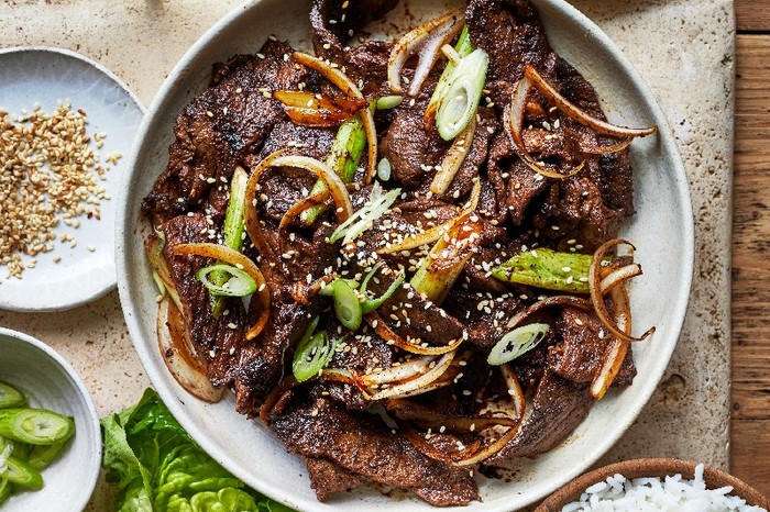 A bowl of Bulgogi topped with sliced spring onions