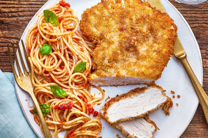Chicken milanese served with spaghetti pomodoro