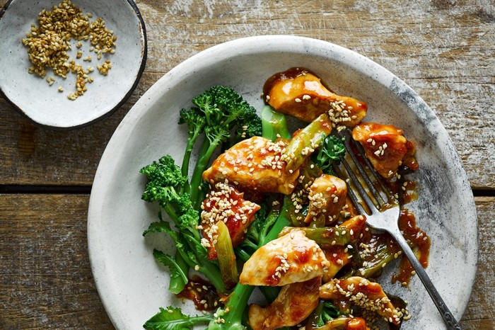 Chicken breast piece in a honey-sesame sauce with long-stemmed broccoli