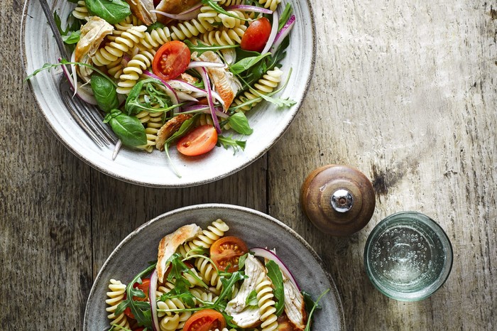 Chicken Pasta Salad with Tomatoes and Rocket in Two Bowls