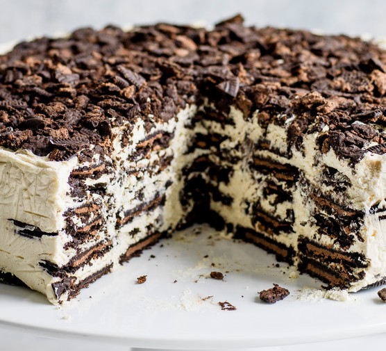 Oreo Baileys fridge cake, with a large chunk taken out to reveal the layered filling