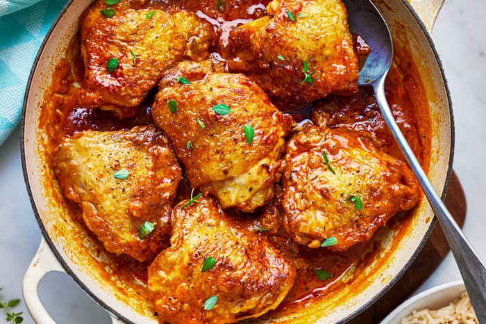 Pot of chicken thighs in a paprika sauce